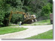 Big CAT, taking out the old garage concrete slab