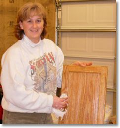 Wiping the stain from the cabinet door