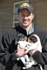 Todd bringing puppies outside from the Puppy Cottage